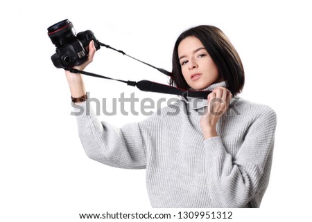 Beautiful female photographer posing with camera