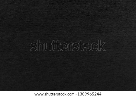 Black paper or cardboard texture as background