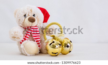 Christmas teddy bear on a white table.