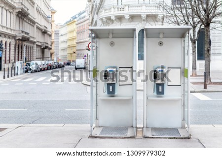 Pair of payphone booth in Vienna center street. Two modern public phones on european city street. copyspace Royalty-Free Stock Photo #1309979302
