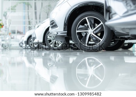 Cars For Sale, Automotive Industry, Cars Dealership Parking Lot. Rows of Brand New Vehicles Awaiting New Owners, on the epoxy floor in new car service Royalty-Free Stock Photo #1309985482