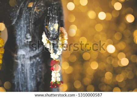 Buddha statue with flowers and leaft in Songkran festival water ceremony 