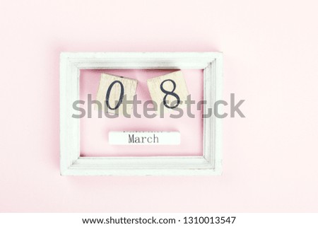 Wooden block calendar International of March 8 on a pink background. Womens Day, is celebrated every year.Holiday concept.Flat lay, top view, copy space