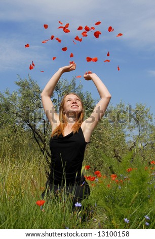 happy  teenager in a field of spring flowers