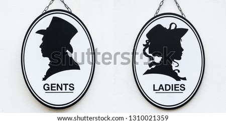 Toilet sign in vintage or classic style lady or woman and gentleman or man symbol on wall WC.