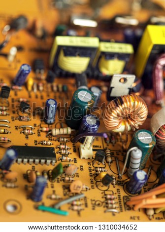 Electronic circuit board with components, close up image. Electronics recycling or electronics repair conceptual picture.