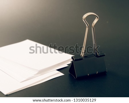 stationery metal clip for paper on a black background