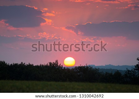 Good morning! Colorful sunrise with big sun ball over the country with lot of sun rays and clouds, beautiful background Picture wirh unbelievable colors and atmosphere, Slovakia