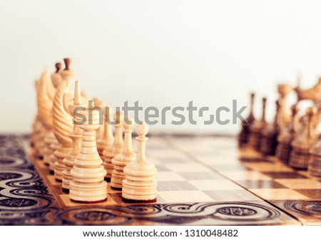 Wooden chess pieces on a chessboard, leadership concept on white background