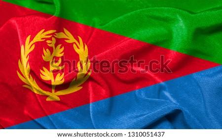 Realistic flag of Eritrea on the wavy surface of fabric
