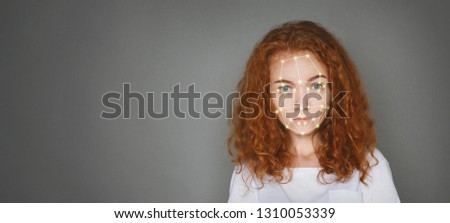 Future technologies and security. Scanning of redhead woman face for biometric verification, free space