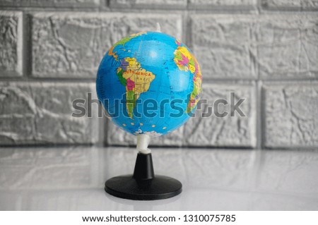 Globe atlas isolated on silver background.
