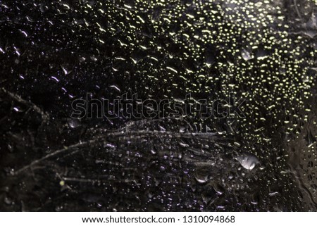 water drop on black . macro close up .raining glass isolated black background