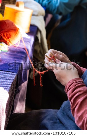 needlework hobby girls hands weaving making items of clothing vertical photo