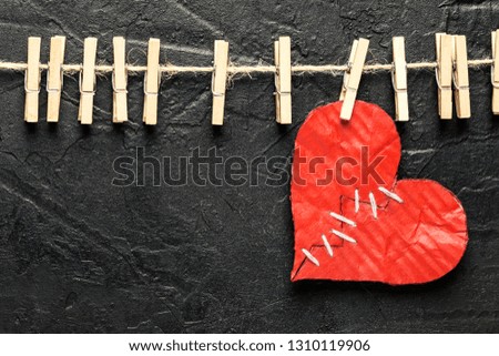 Stitched heart hanging on rope with copy space. Valentine's Day background
