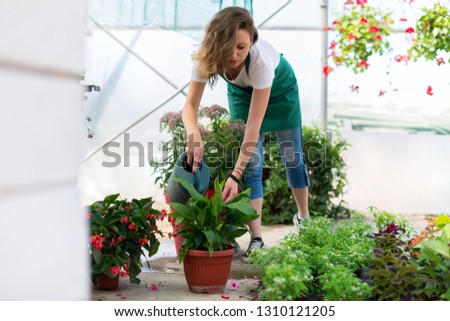 Young woman watering the flowers