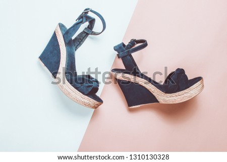 Female sandals on a platform on a colored paper background. on form. Fashionable summer shoes