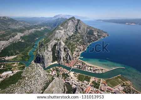 Aerial view - Omis city in Croatia. between Adriatic sea, mountain Omiska Dinara and river Cetina Royalty-Free Stock Photo #131013953
