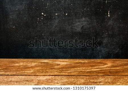 The surface of the rough wooden table top and school Board stained with chalk. Abstract background.
