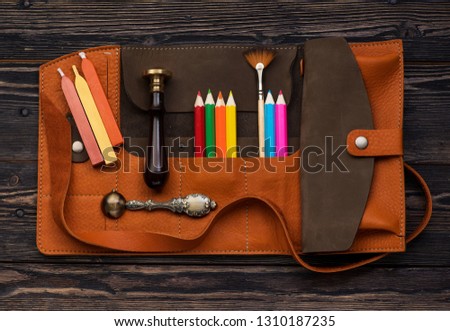 leather case with accessories for creativity. Wax seal, sealing wax, brush and pencils in leather organizer