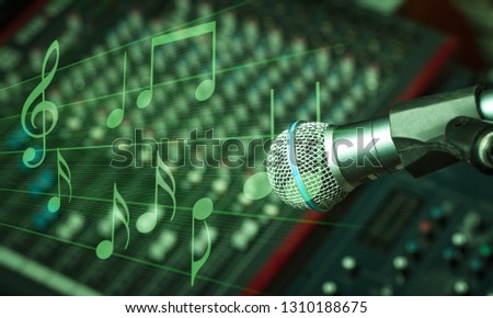 Microphone and  digital studio mixer  on background