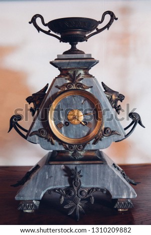 Antique gold clock on wood background