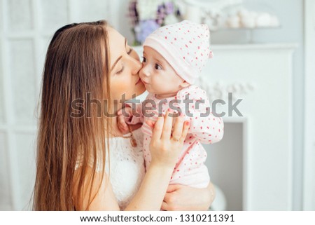A young mother and her little daughter. Mother's love for her daughter