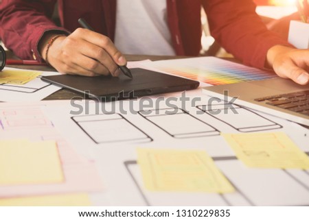 Web designer planning application for mobile phone. Design application development draft sketch drawing online Technology Content.User experience concept.

