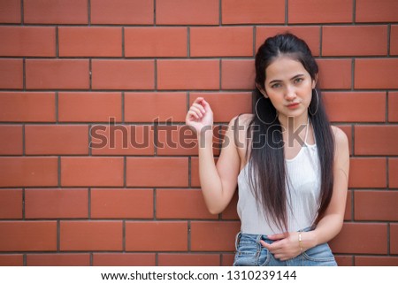 Portrait of beautiful asian chic girl pose for take a picture on wall background,Lifestyle of teen thailand people,Modern woman happy concept,Punk rock style