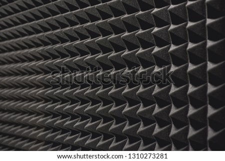 Nobody will hear you. Close up view of a grey soundproof coverage on the wall in music studio. Musical instruments. Live music