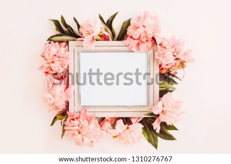 Pastel wooden frame decorated with coral peonies flowers, empty space for text