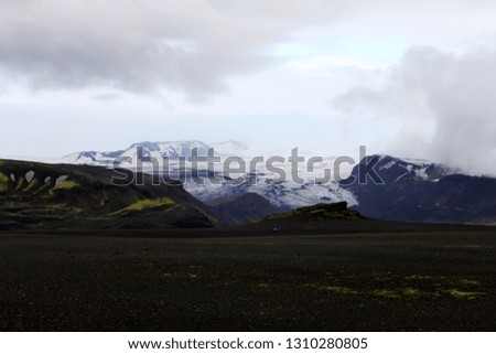 This picture show you a glacier in iceland at the Laugavegur trail with two travellers.