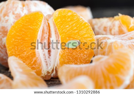 delicious tangerines, peeled orange peel lying on a wooden table, healthy citrus fruits with lots of vitamins