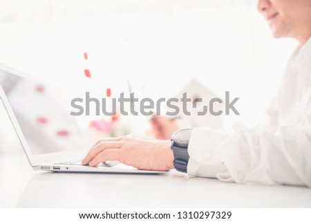 Close-up businessman hands typing on laptop keyboard