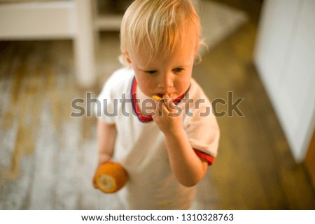 Toddler eating an orange