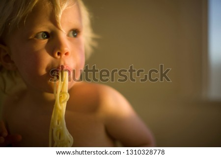 Little boy slurping spaghetti