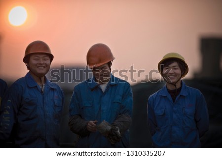 Construction workers sharing a laugh at sunset