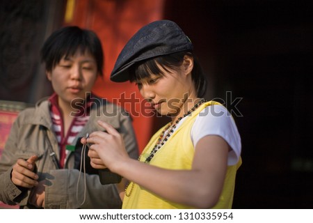 Teenage girl holding a digital camera.