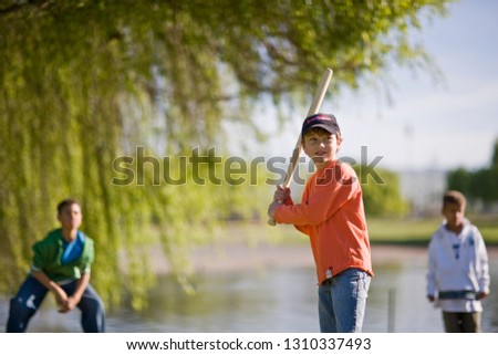 Friends playing softball in park