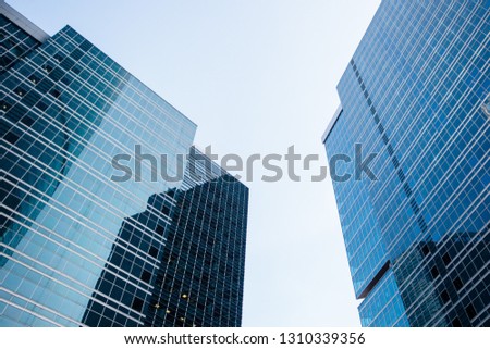 underside panoramic and perspective view to steel blue glass high rise building skyscrapers, industrial architecture