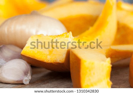 Sliced orange ripe pumpkin while cooking vegetables