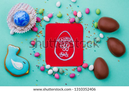 Easter greeting card and candies. Picture of egg on red card, sweets and chocolate. Ideas of greeting card for children.