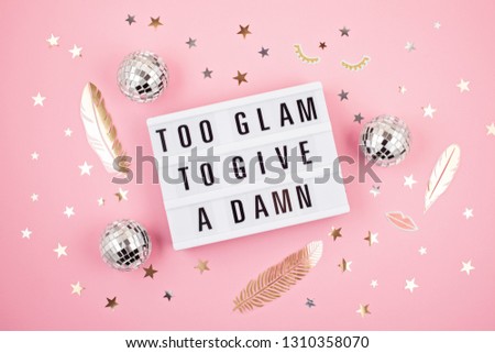 Flat lay of  lightbox with funny motivation, inspiration phrase Too glam to give a damn