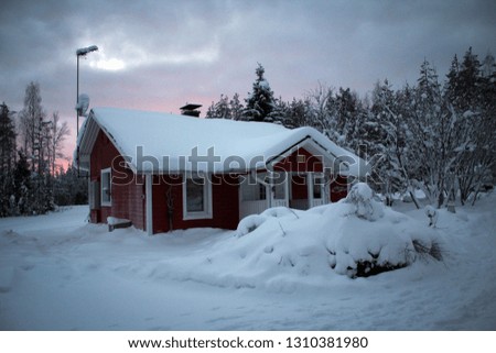 Scenic house in deep forest, winter in Lapland, Finland