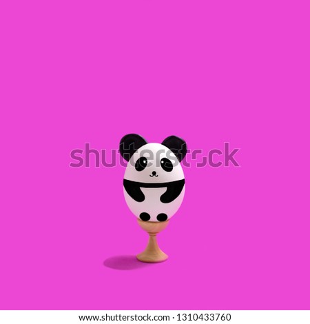 Handmade cute panda made of egg on wooden stand. Creative Easter decor, kawaii style. Minimal easter concept