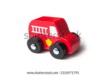 closeup of red  miniature wooden truck on white background - concept fire rescue