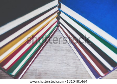 Background of multicolored old books close up. The concept of the book as a symbol of knowledge