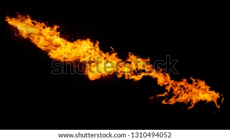 Dragon breathing flame, fire stream isolated on black Royalty-Free Stock Photo #1310494052