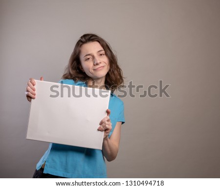 Woman in Blue Shirt Gesturing with a blank sign. Spokeswoman holding a sign with room for copyspace series.