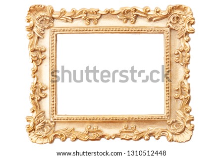 Gold gilt and gilded art carve objects concept theme with a photo frame covered in golden paint adorned with intricate carvings isolated on white background with copy space and a clip path cutout